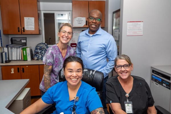 Staff members smiling together in the reception area