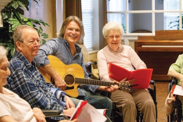 Residents enjoying a music activity in a common area