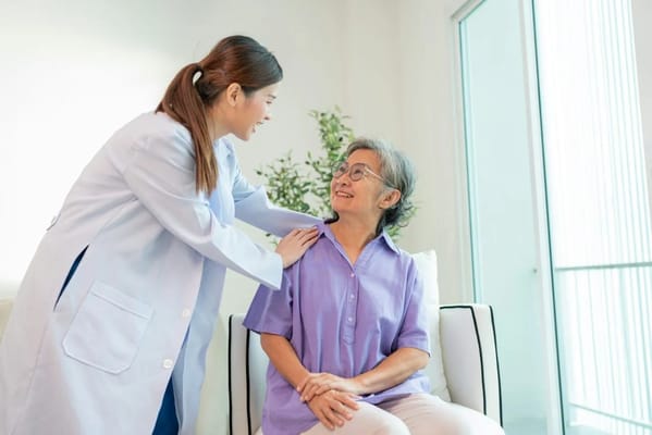A caregiver interacting with a senior resident indoors