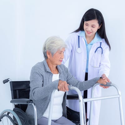A nurse assisting an elderly woman in a wheelchair
