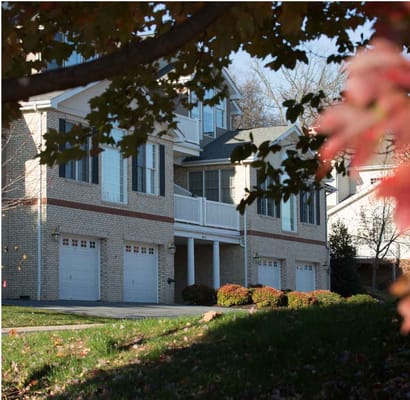Building exterior of a retirement community surrounded by autumn foliage