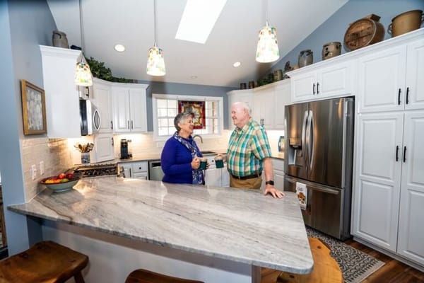 Residents chatting in a bright kitchen area