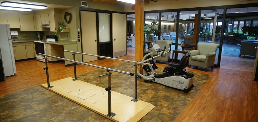 Rehabilitation area with exercise equipment and therapy bars
