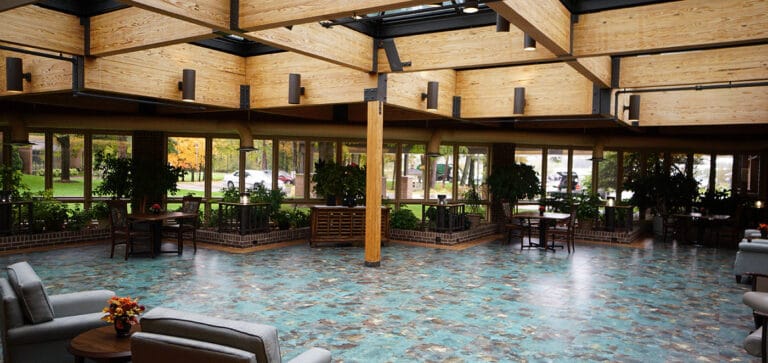 Interior view of a spacious common area with plants and seating