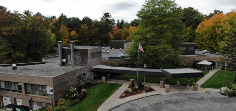 Aerial view of Rennes Health and Rehab Center-East surrounded by trees