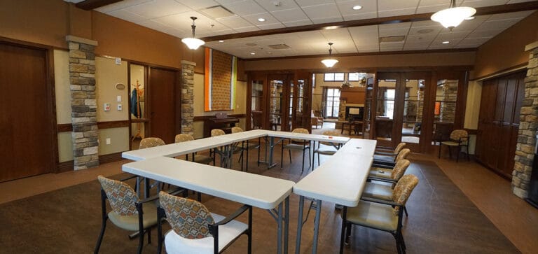 Bright common area with tables and chairs set up