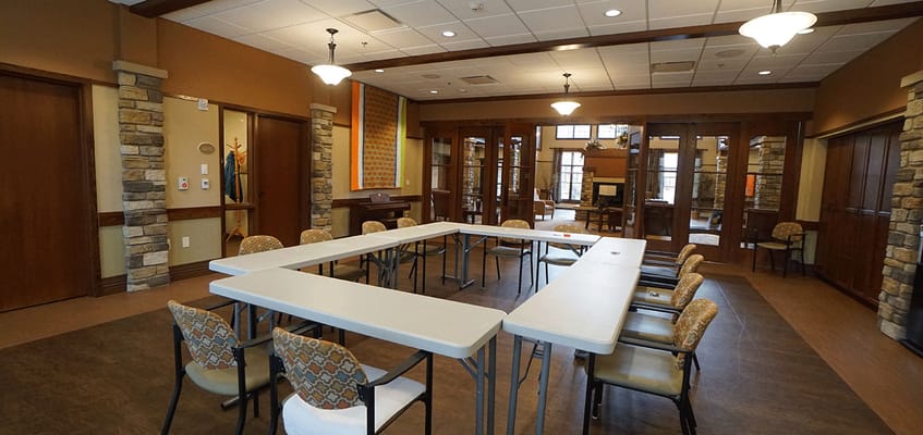 Bright common area with tables and chairs set up