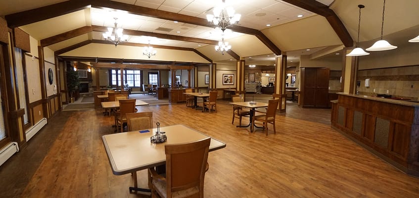 Interior view of a spacious common area with tables and chairs