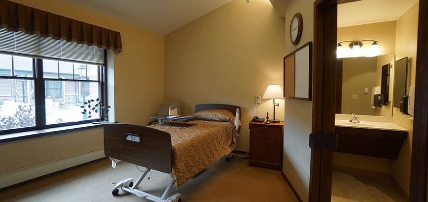 Cozy resident room featuring a bed and seating area