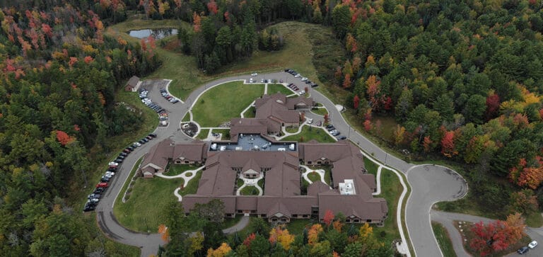 Aerial view of a senior living facility surrounded by trees