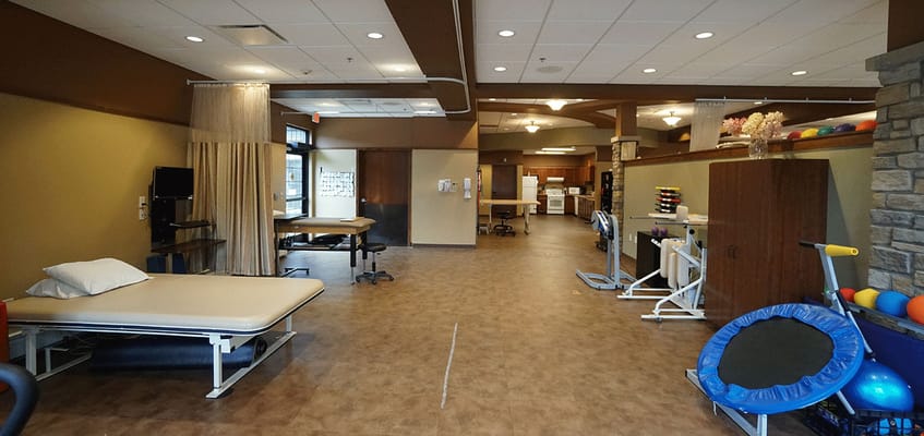 Rehabilitation gym with exercise equipment and therapy space