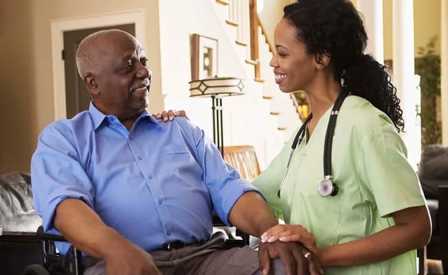 Resident and caregiver smiling in a welcoming interior