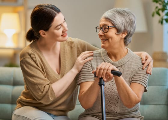 Caregiver and resident sharing a moment in a cozy setting