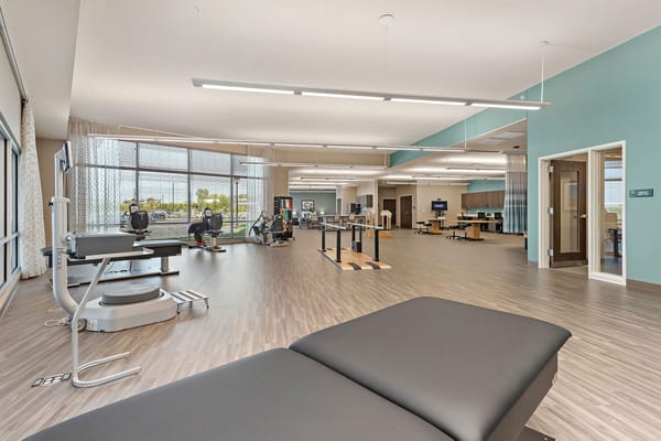 Bright activity room with fitness equipment and natural light