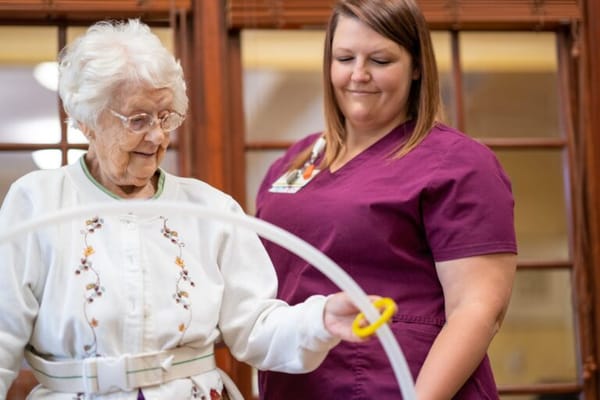 Caregiver assisting a resident in an activity
