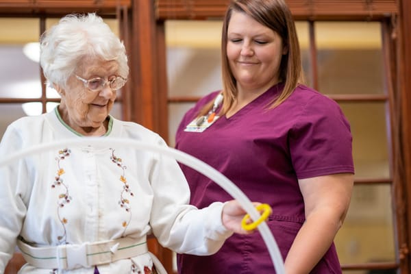 Caregiver assisting a resident in an activity