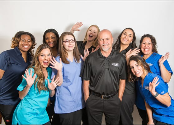 Staff members posing and smiling together in a group