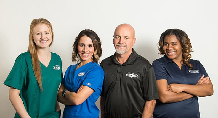 Staff members posing together in uniforms