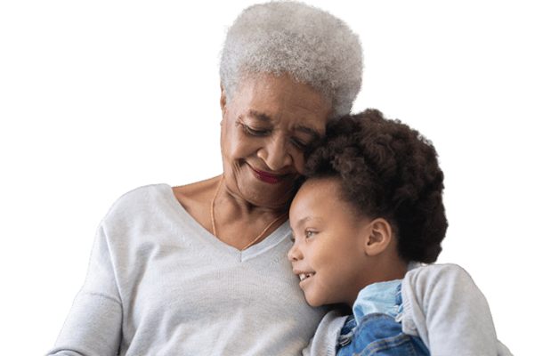An elderly woman smiling with a child
