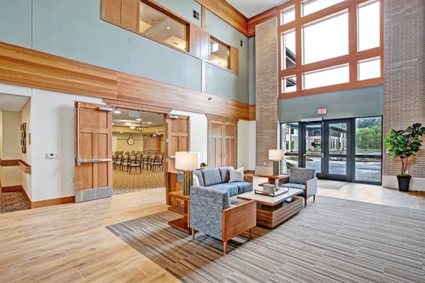 Bright common area with seating and large windows