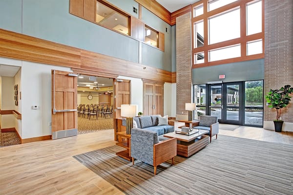 Bright common area with seating and large windows