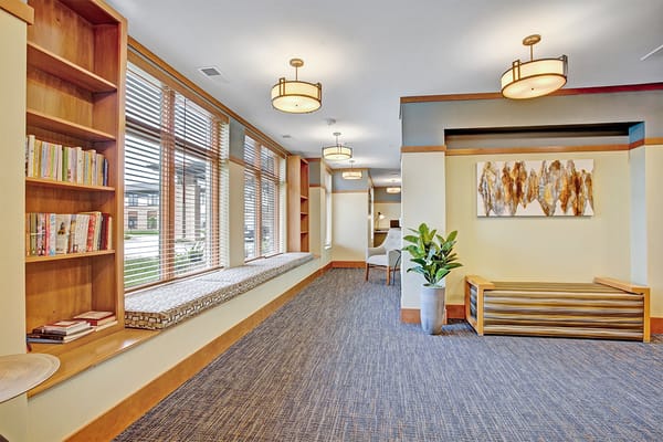 Bright and inviting common area with seating and bookshelves