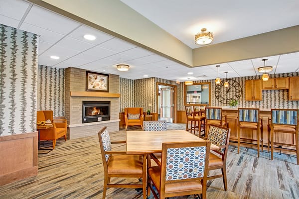 Bright common area with seating and a fireplace