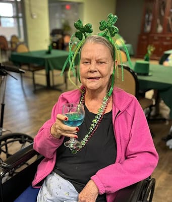 Resident celebrating with decorations at an indoor party