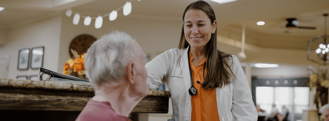 Staff member interacting with resident in a common area