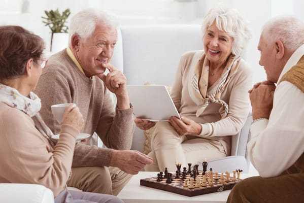 Residents enjoying a game of chess in a common area