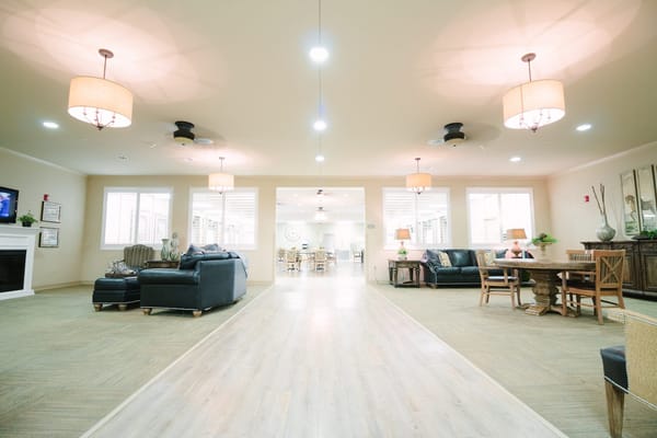 Bright common area with seating and warm lighting