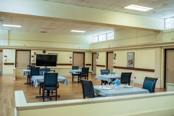 Bright dining room with tables set for meals