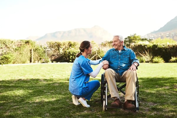 Nurse interacting with a resident in a garden