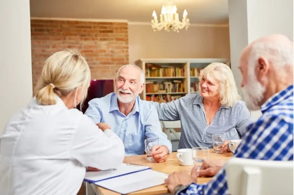 Residents engaging with staff around a table