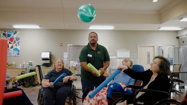 Residents engaged in a group activity with exercise balls