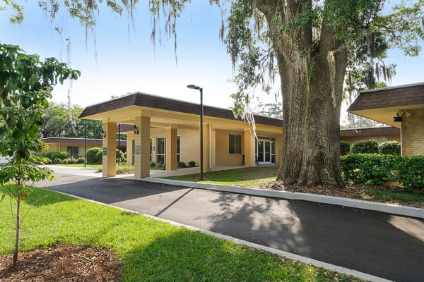 Building exterior of Camellia Gardens with landscaped entrance