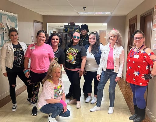 Staff members posing in a hallway during an event