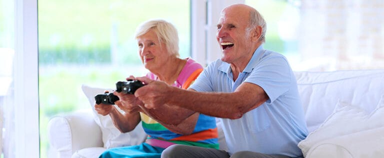 Residents enjoying video games in a cozy common area