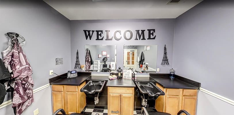 Interior view of a hair salon with welcome sign