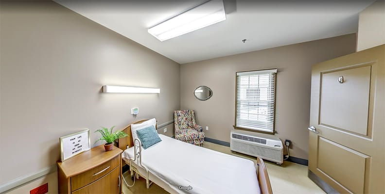 Cozy private resident room with chair and bed