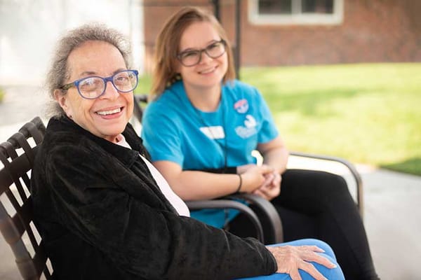 Resident and staff member enjoying time outside
