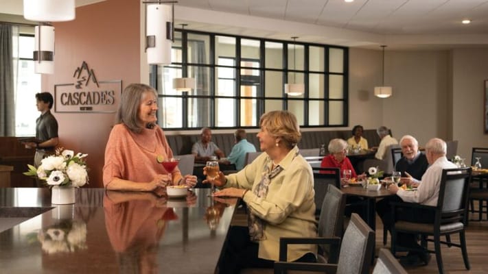 Residents enjoying drinks in a dining area