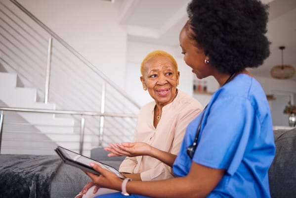 Nurse interacting with an elderly resident in a comfortable setting