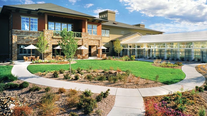 Exterior view of the assisted living facility with gardens