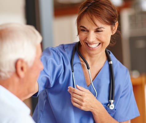 A caregiver smiling with a resident in a friendly interaction