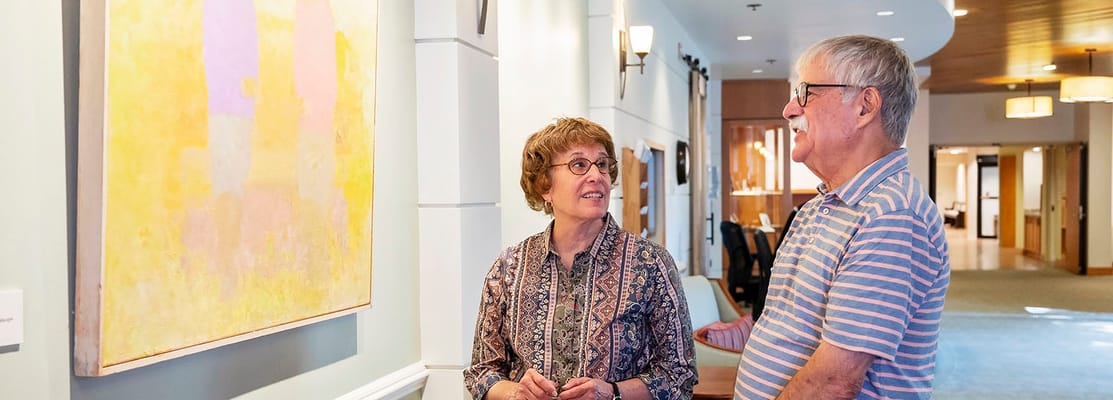 Residents admiring artwork in a hallway