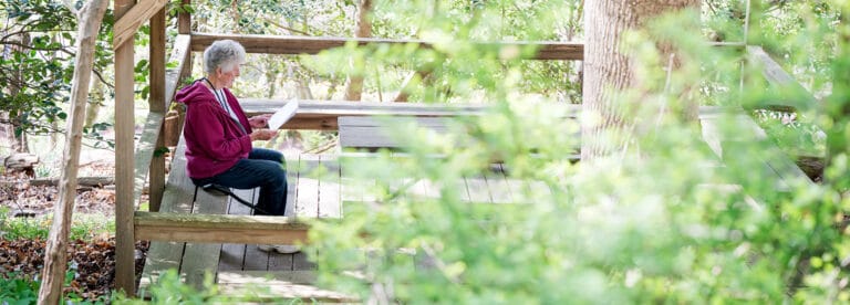 Resident enjoying quiet time in a garden pavilion