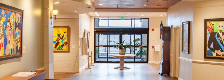 Bright interior hallway with artwork and plants