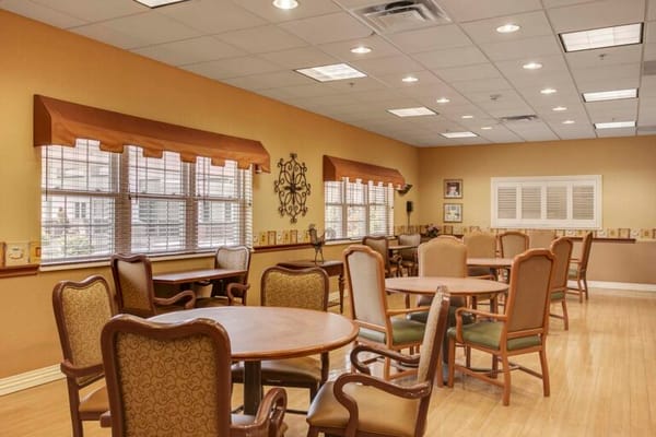 Interior view of a communal activity room with tables and chairs