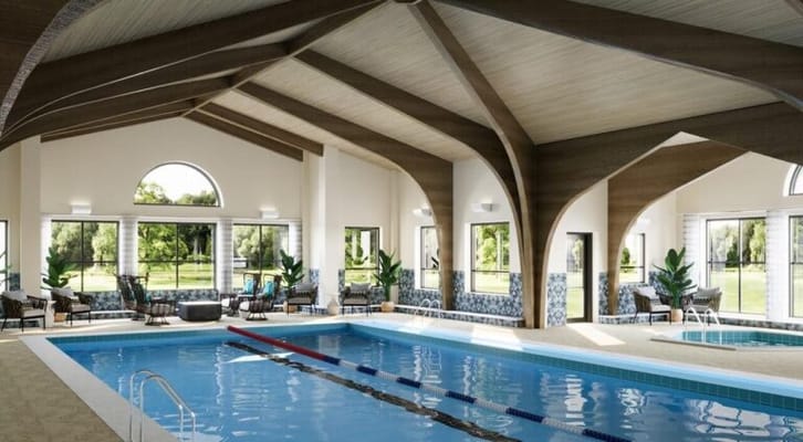 Indoor swimming pool area with natural light and seating